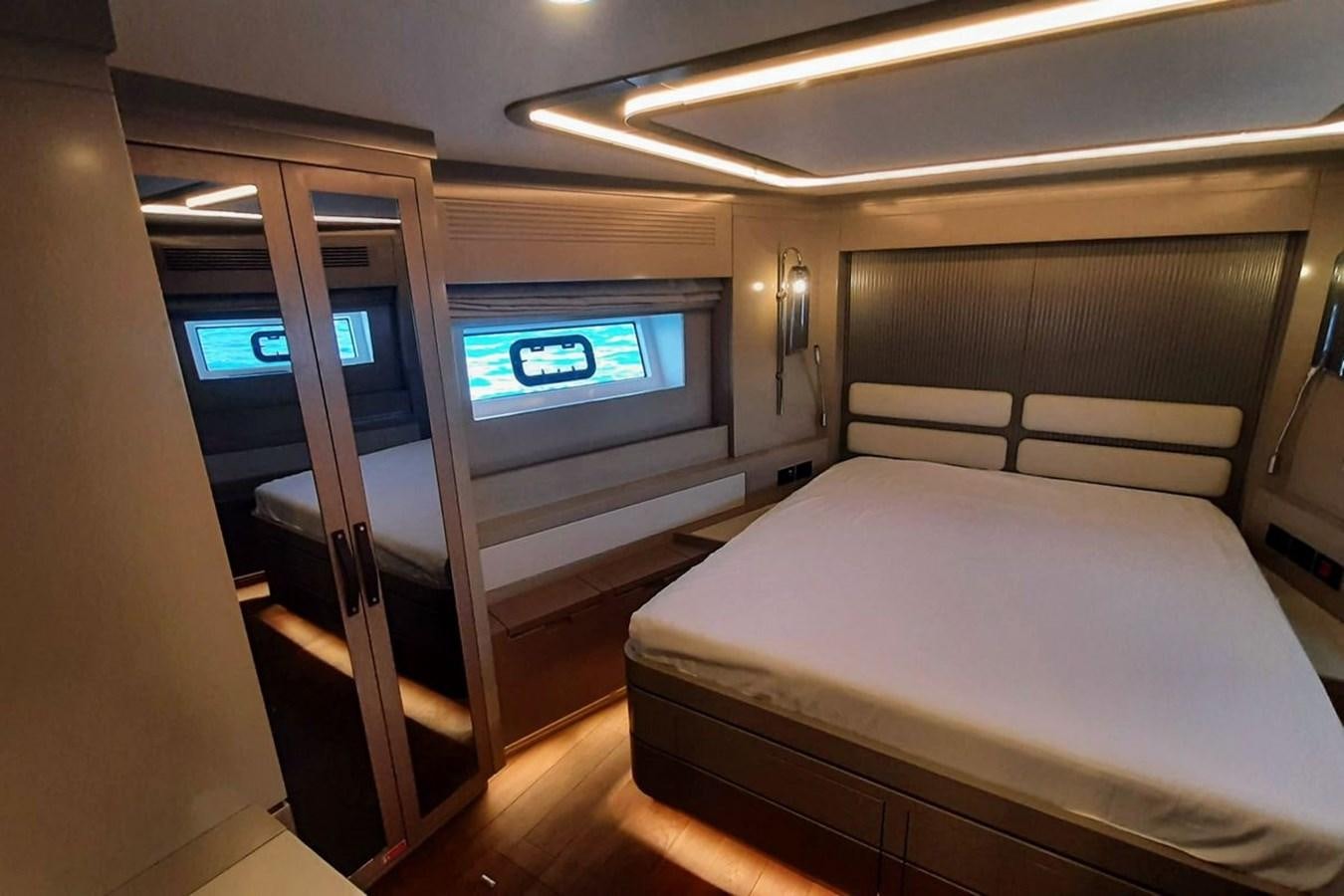 a room with a bed and a window aboard SIRENA 68 Yacht for Sale