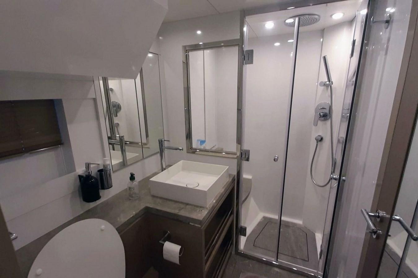 a bathroom with a glass shower aboard SIRENA 68 Yacht for Sale