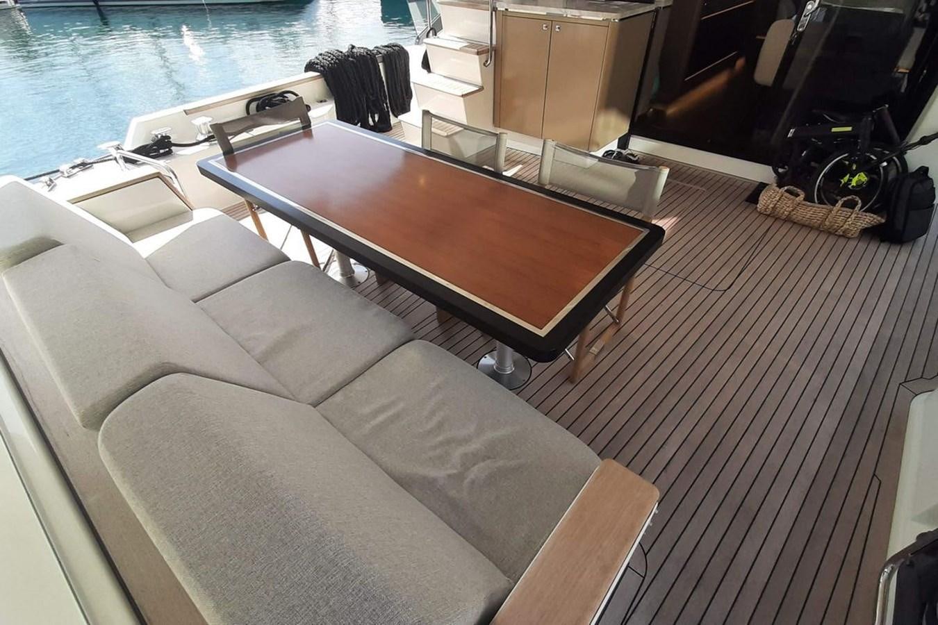 a room with a table and chairs aboard SIRENA 68 Yacht for Sale
