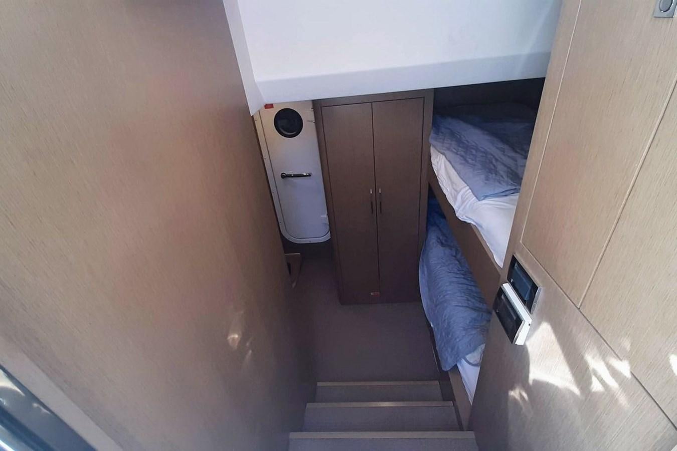 a small room with a bed and a small table aboard SIRENA 68 Yacht for Sale