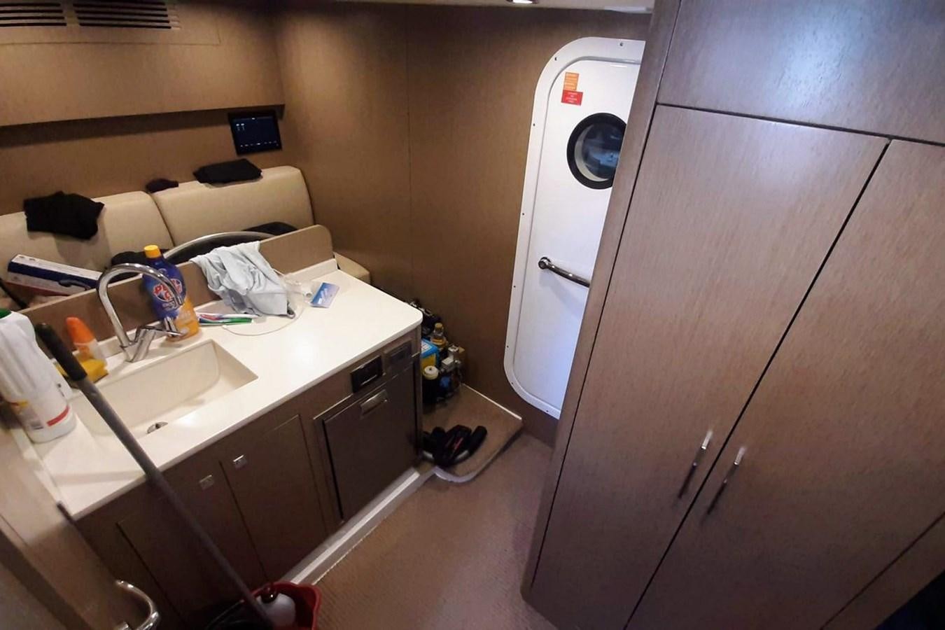 a room with a desk and a bed aboard SIRENA 68 Yacht for Sale