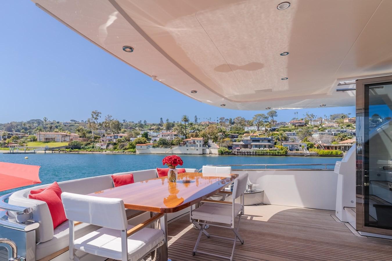 a table and chairs on a deck overlooking a city aboard GYRFALCON Yacht for Sale