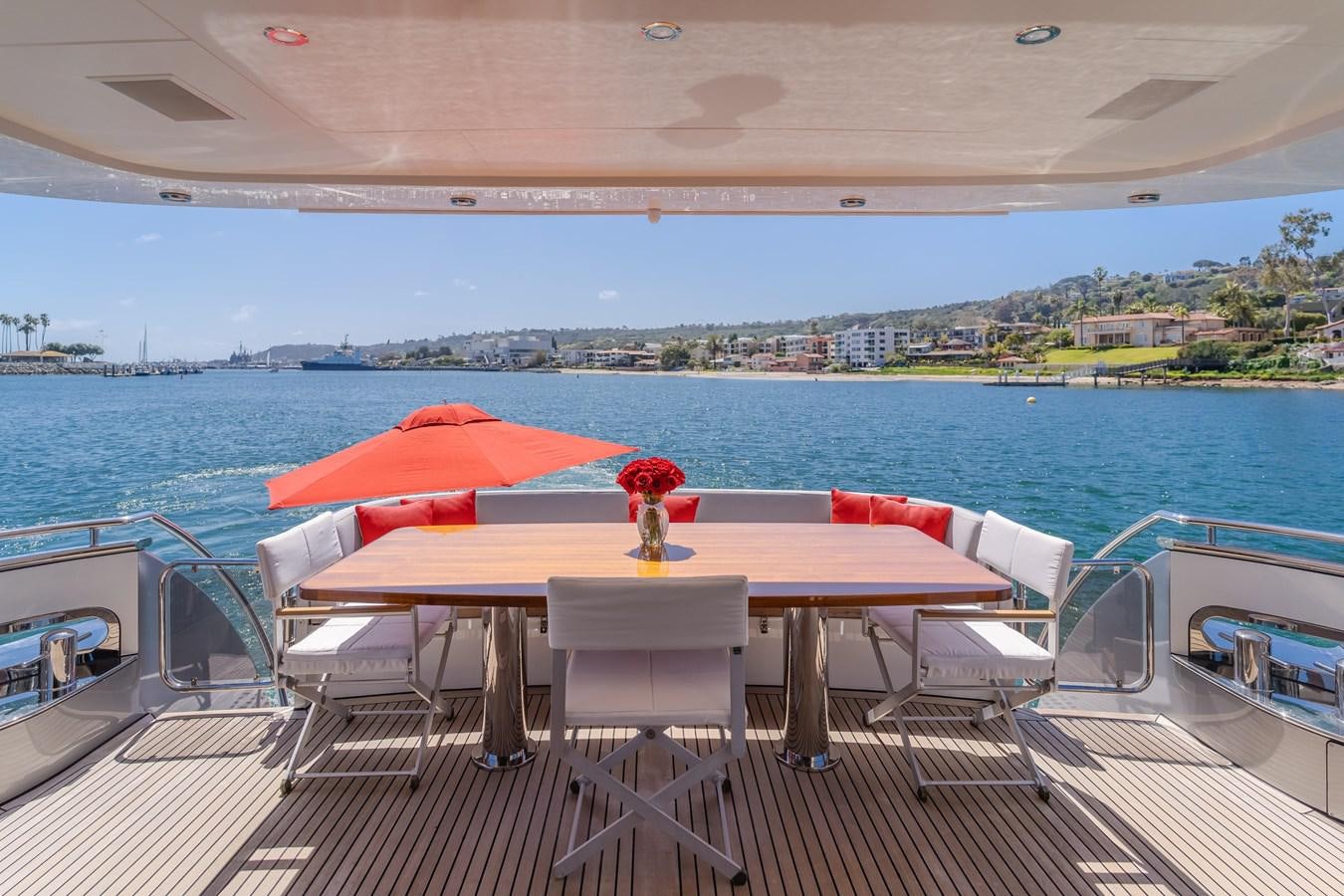 a table on a deck overlooking a body of water aboard GYRFALCON Yacht for Sale