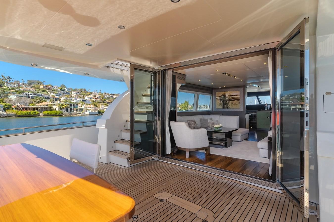 a modern looking living room with a balcony aboard GYRFALCON Yacht for Sale