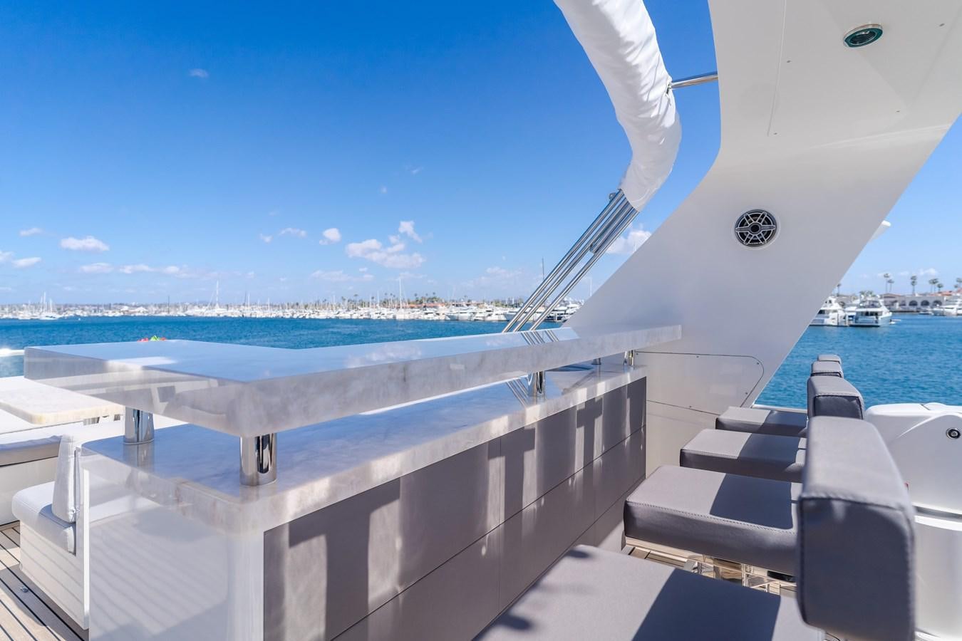 a deck of a boat with a large body of water in the background aboard GYRFALCON Yacht for Sale