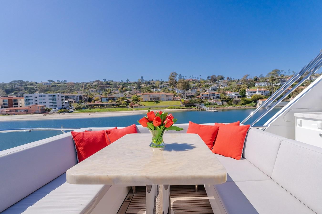 a balcony with a table and chairs with flowers on it aboard GYRFALCON Yacht for Sale