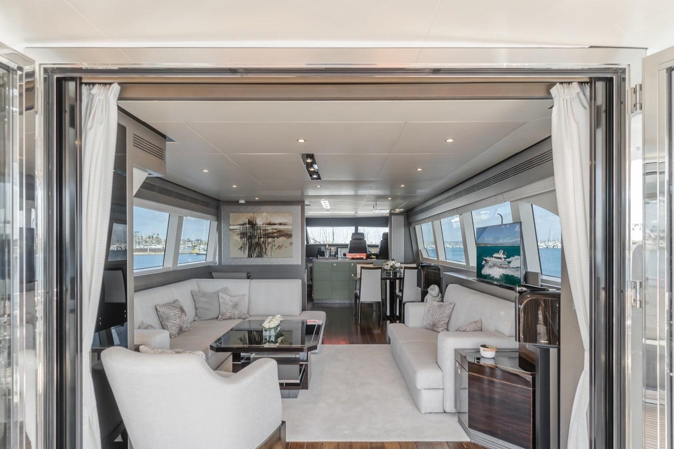 a living room with a large window aboard GYRFALCON Yacht for Sale