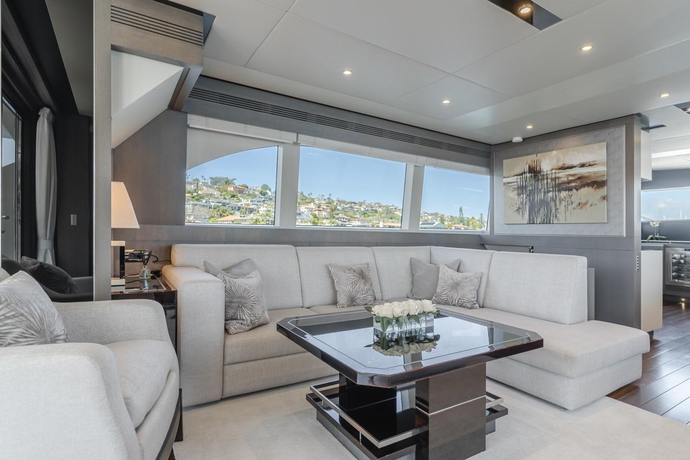 a living room with a large window aboard GYRFALCON Yacht for Sale