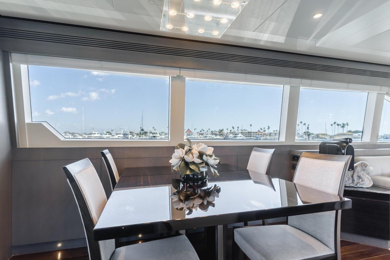 a room with tables and chairs aboard GYRFALCON Yacht for Sale