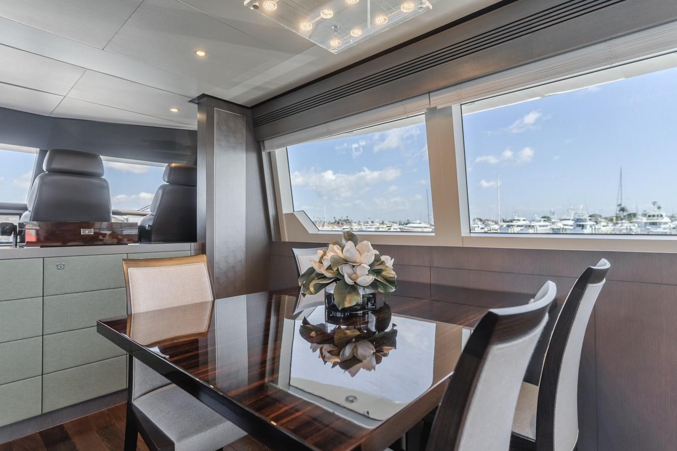 a table with chairs and flowers on it aboard GYRFALCON Yacht for Sale