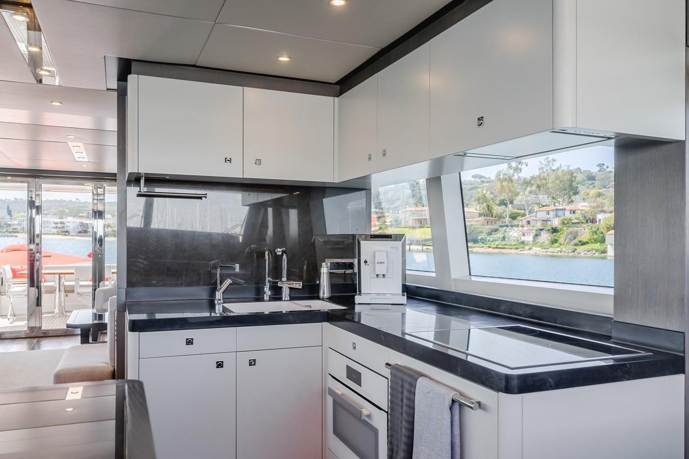 a kitchen with a large window aboard GYRFALCON Yacht for Sale