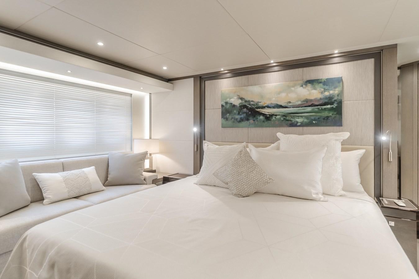 a bed with white sheets and pillows aboard GYRFALCON Yacht for Sale