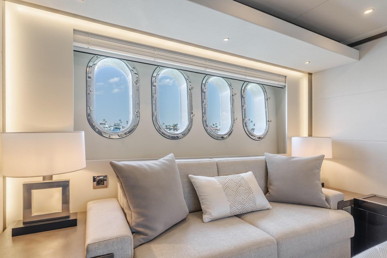 a couch with a large mirror above it aboard GYRFALCON Yacht for Sale