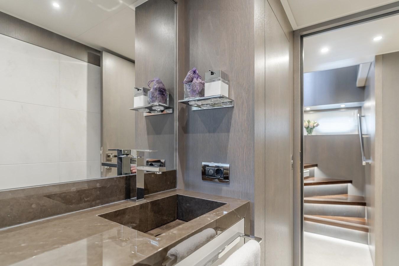 a bathroom with a tub and a sink aboard GYRFALCON Yacht for Sale