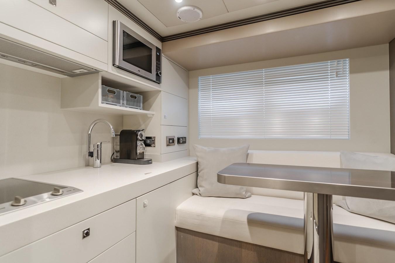 a small kitchen with a sink and microwave aboard GYRFALCON Yacht for Sale