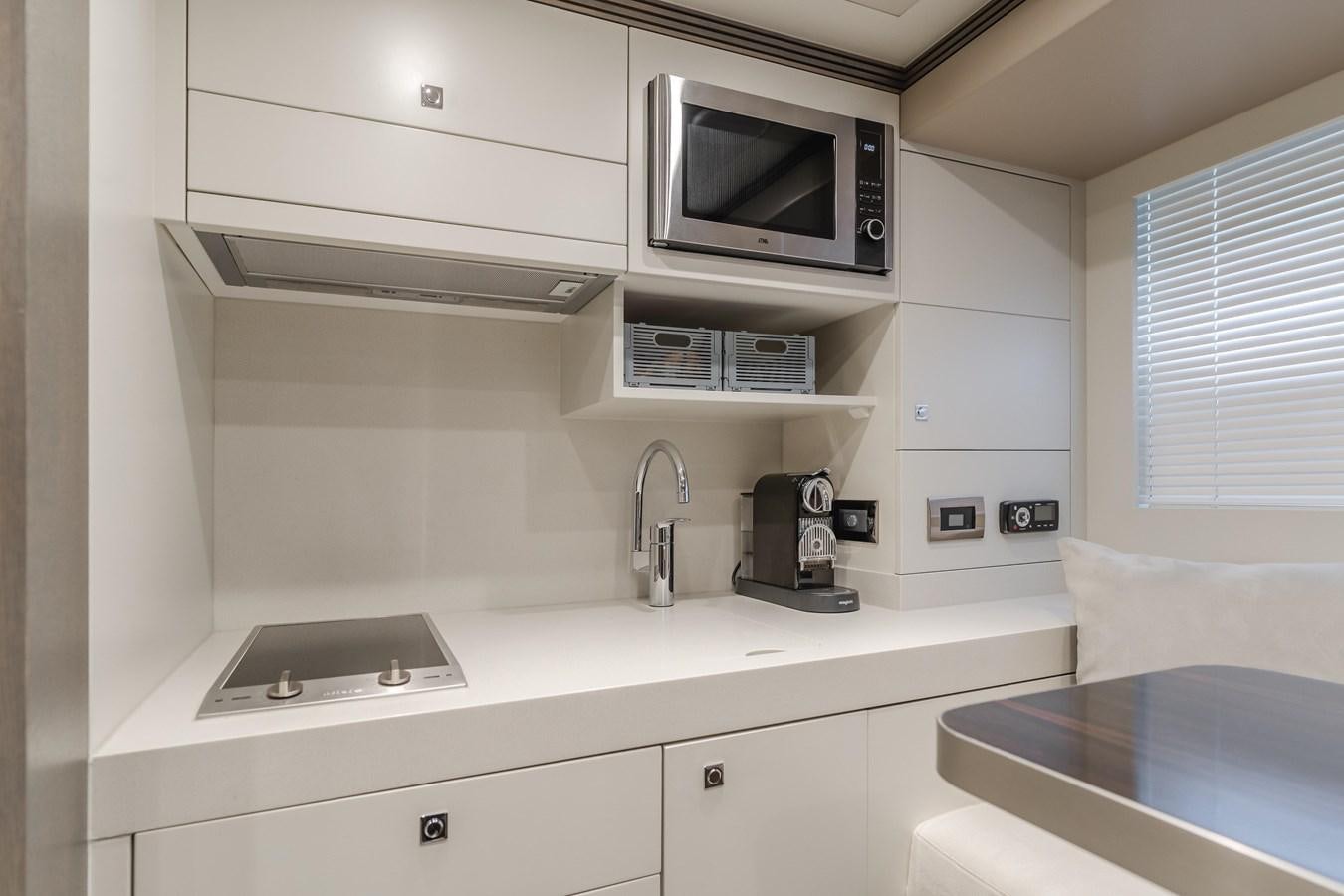 a kitchen with a microwave oven and a sink aboard GYRFALCON Yacht for Sale