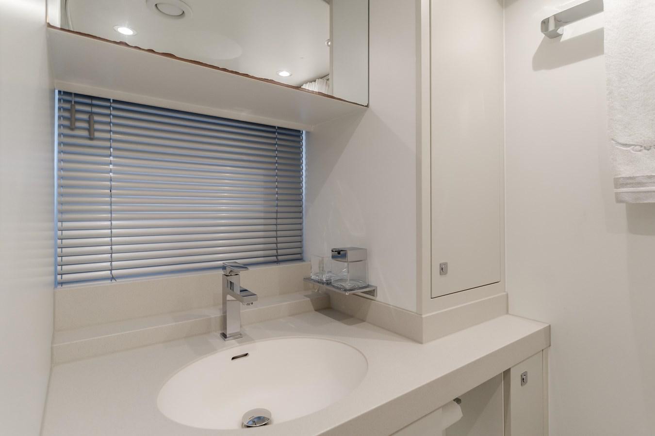 a bathroom with a sink and a window aboard GYRFALCON Yacht for Sale