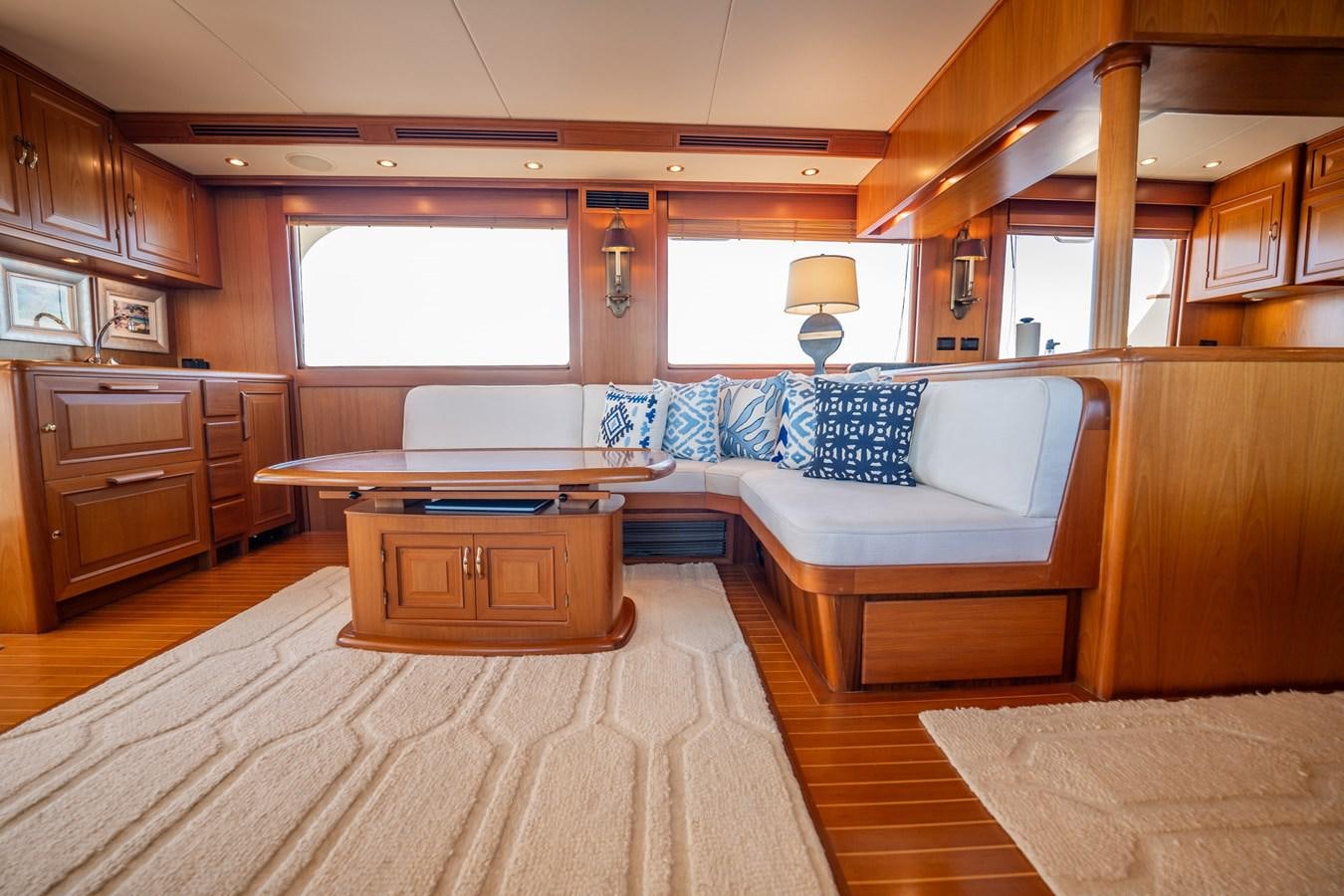 a large living room with a kitchen aboard BEBA Yacht for Sale