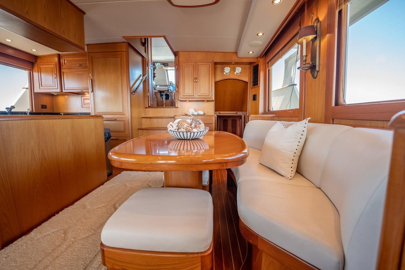 a living room with a table and couch aboard BEBA Yacht for Sale