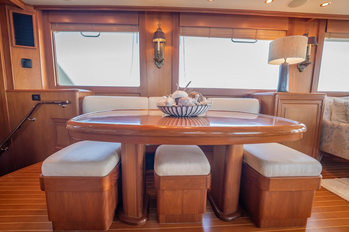 a kitchen with a table and stools aboard BEBA Yacht for Sale
