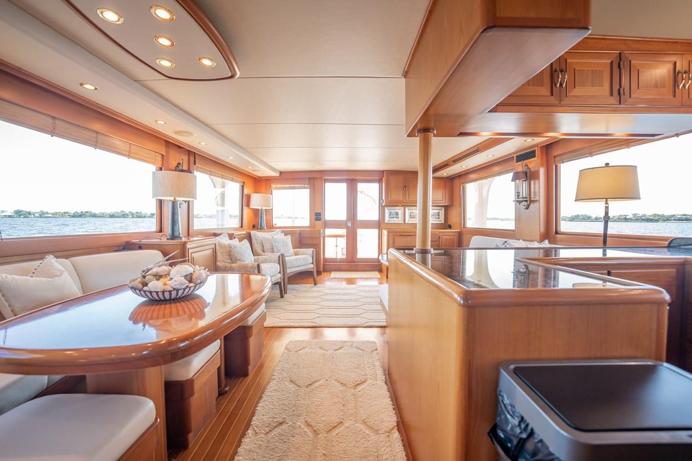 a large living room with wood furniture aboard BEBA Yacht for Sale