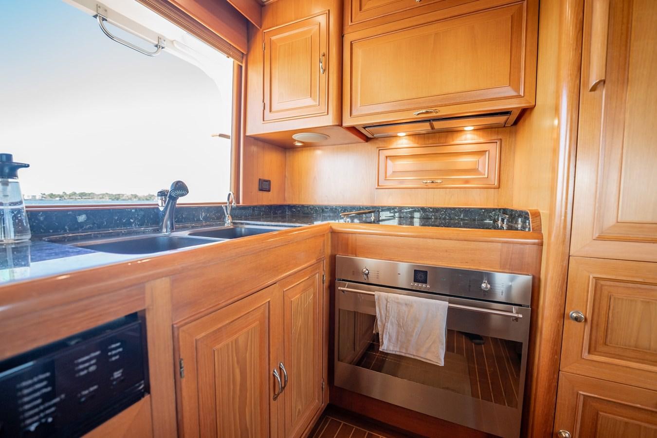a kitchen with wooden cabinets aboard BEBA Yacht for Sale