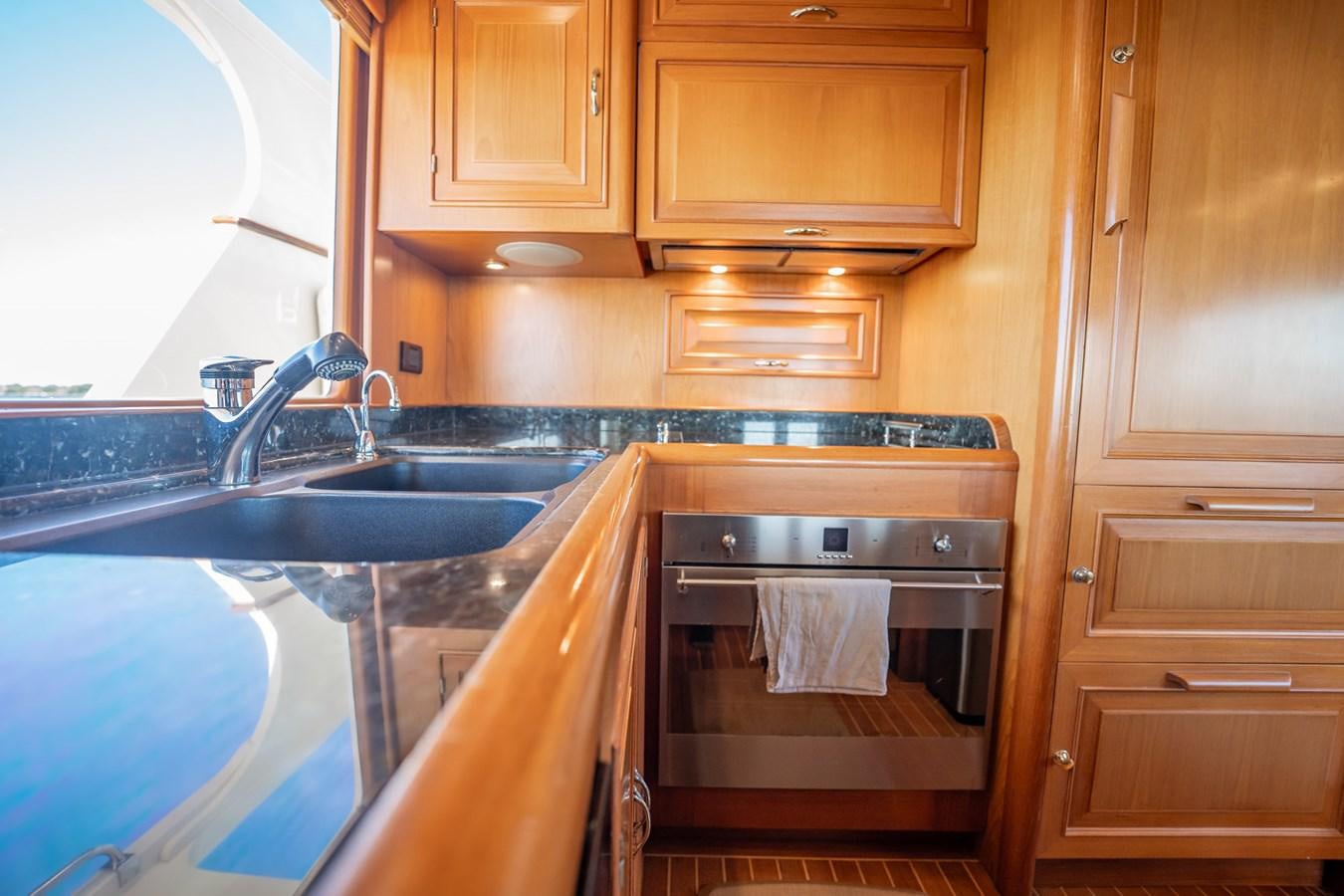 a kitchen with wooden cabinets aboard BEBA Yacht for Sale