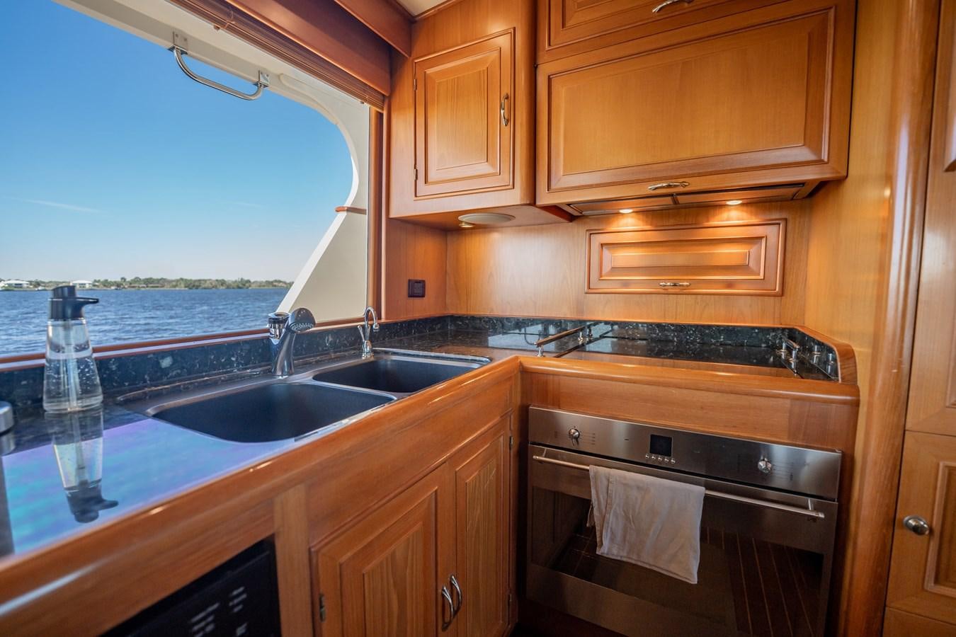 a kitchen with wooden cabinets aboard BEBA Yacht for Sale