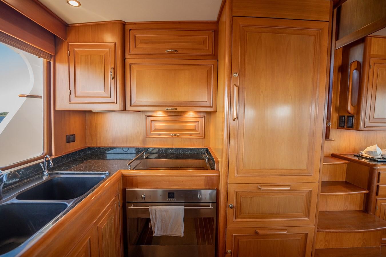a kitchen with wooden cabinets aboard BEBA Yacht for Sale
