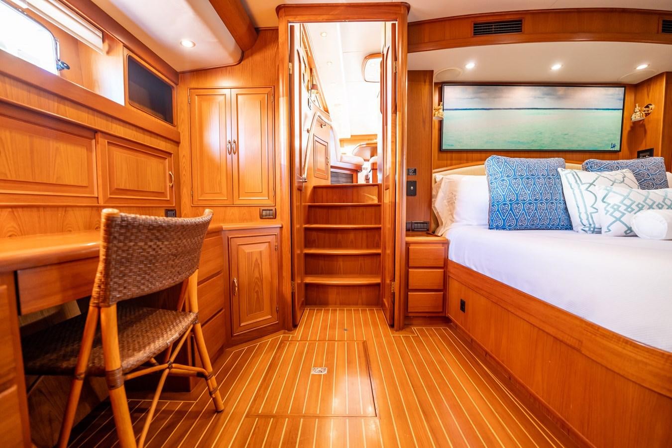 a bedroom with a bed and a chair aboard BEBA Yacht for Sale