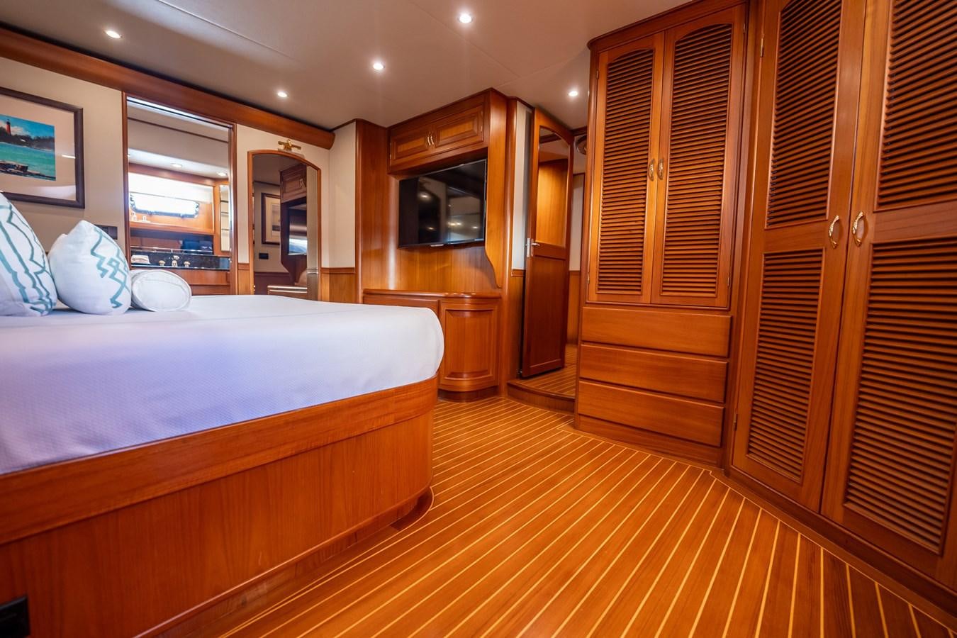 a bedroom with a bed and a tv aboard BEBA Yacht for Sale