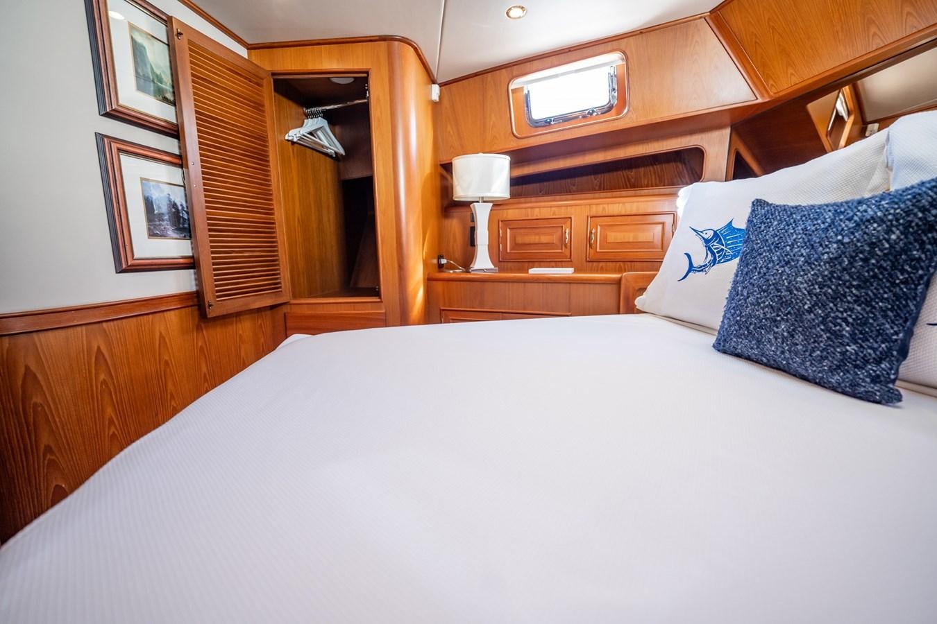 a bed with a white sheet and pillows aboard BEBA Yacht for Sale