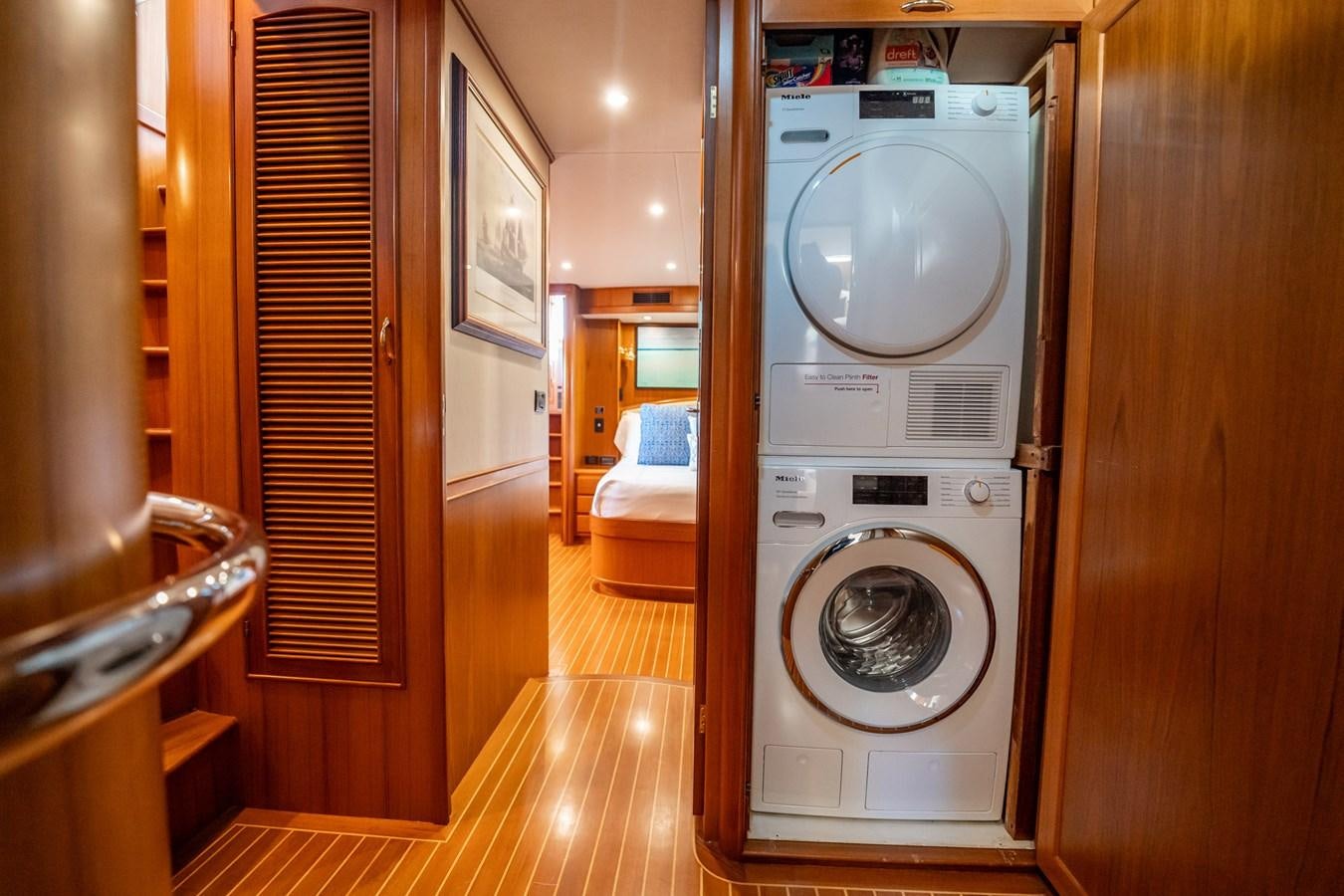 a room with a washing machine and a bed aboard BEBA Yacht for Sale