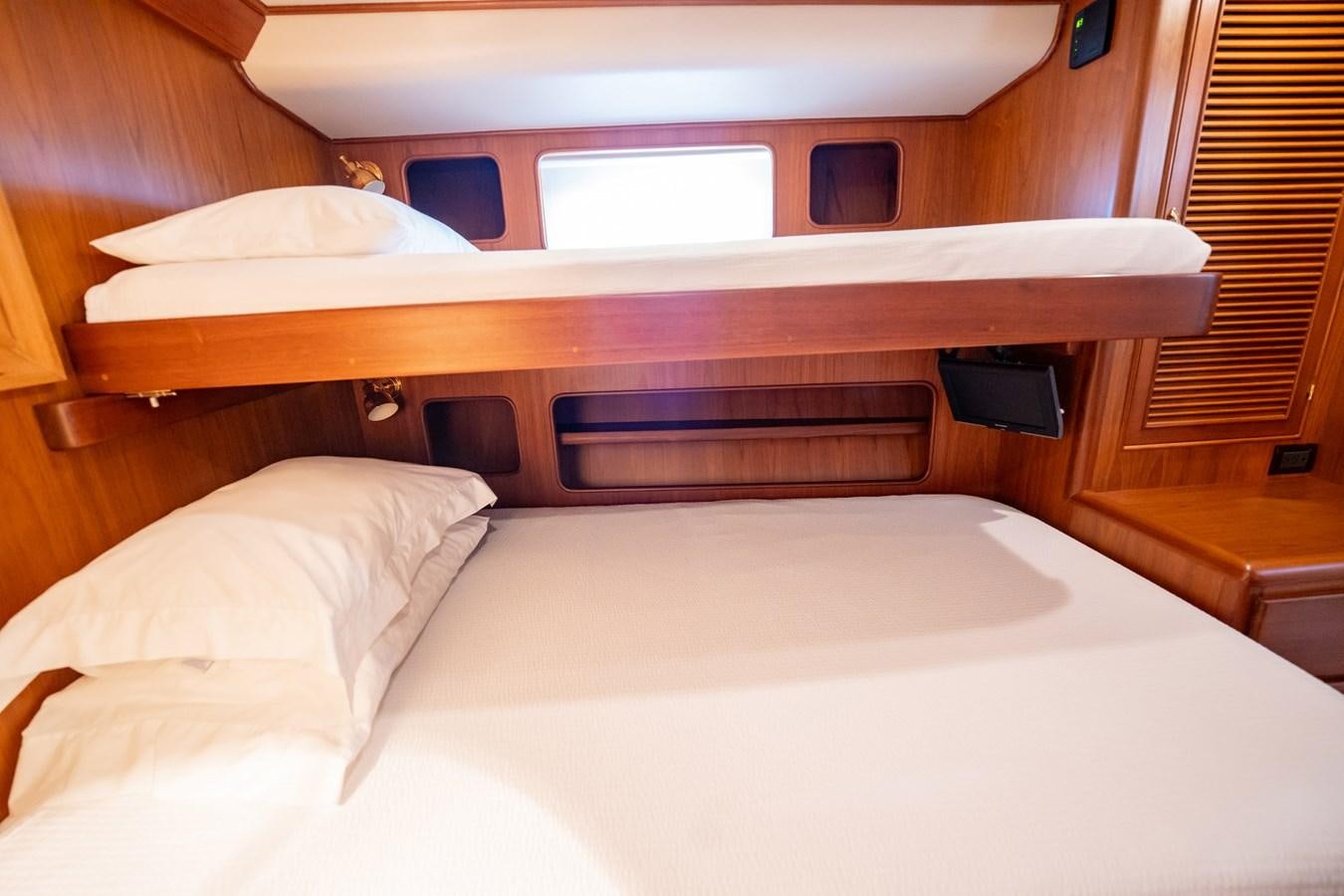 a bed with white sheets aboard BEBA Yacht for Sale