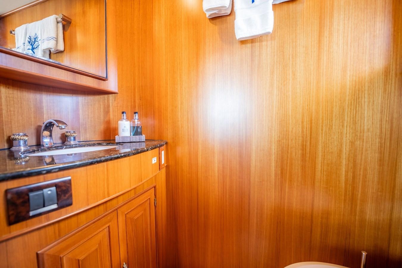 a kitchen with wooden cabinets aboard BEBA Yacht for Sale