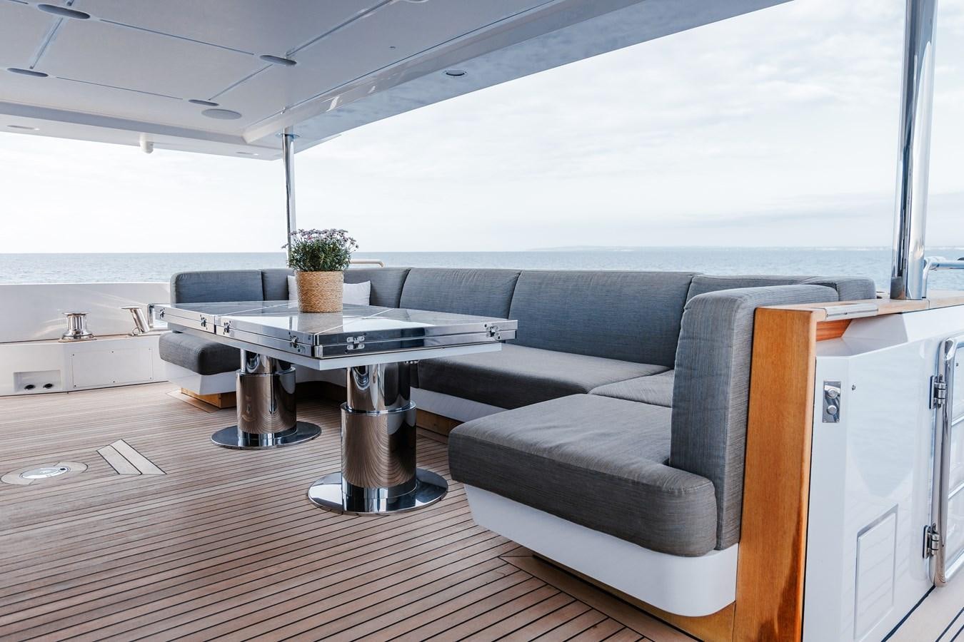 a room with a couch and a table aboard IRYNA Yacht for Sale