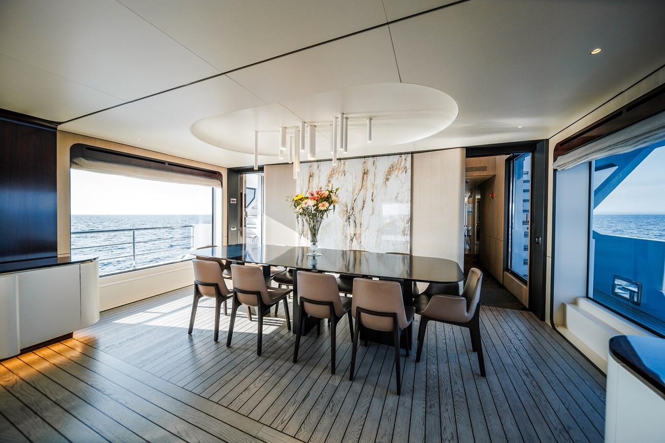 a large dining room with a table and chairs aboard IRYNA Yacht for Sale