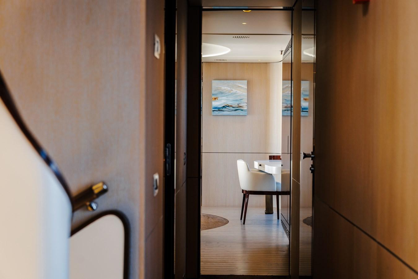 a room with a table and chairs aboard IRYNA Yacht for Sale