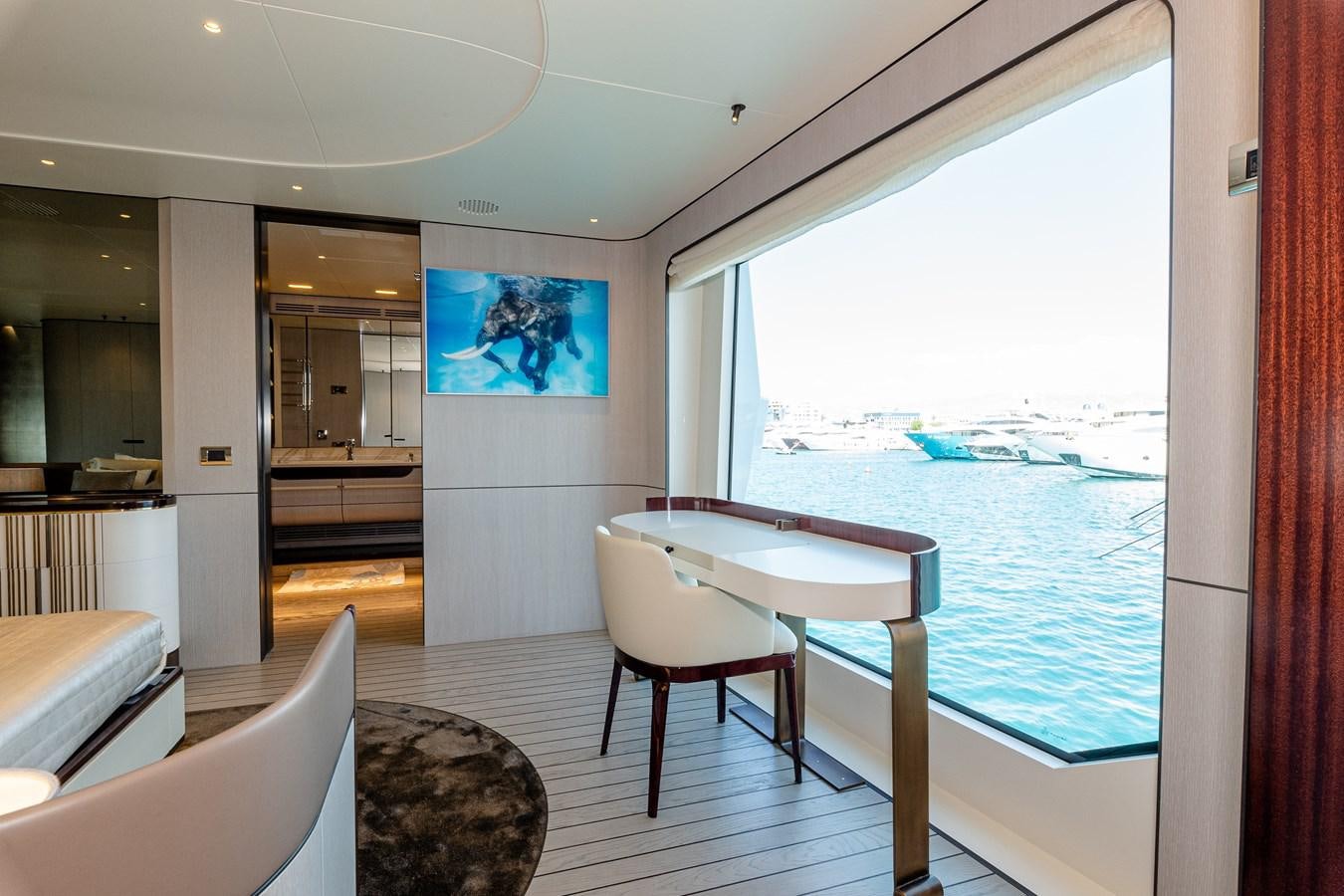 a room with a table and chairs aboard IRYNA Yacht for Sale