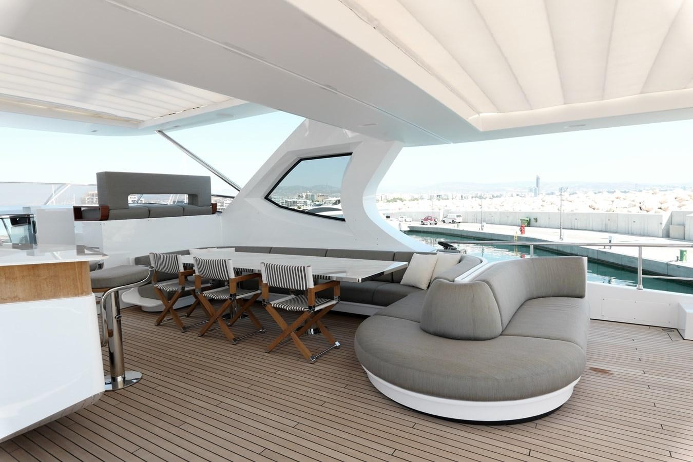 a room with a couch and a table and chairs aboard IRYNA Yacht for Sale