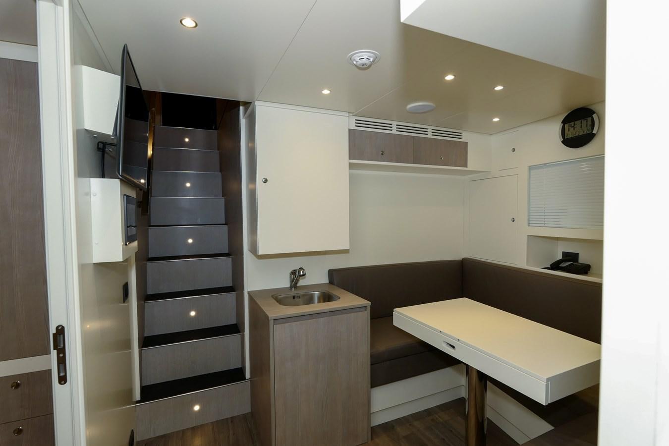 a room with a bed and a sink aboard IRYNA Yacht for Sale