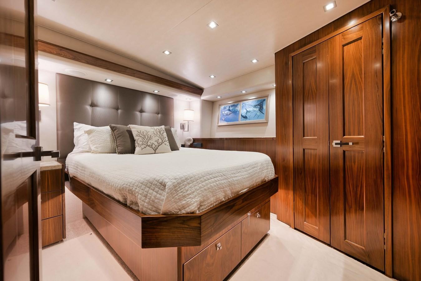 a bedroom with a bed and a closet aboard COOKIE MONSTER Yacht for Sale