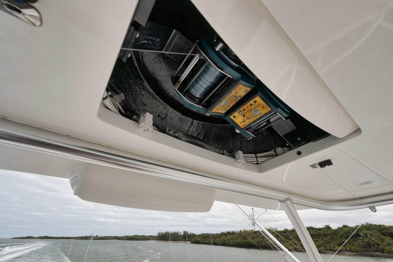 a white car with a yellow sign on the front aboard COOKIE MONSTER Yacht for Sale