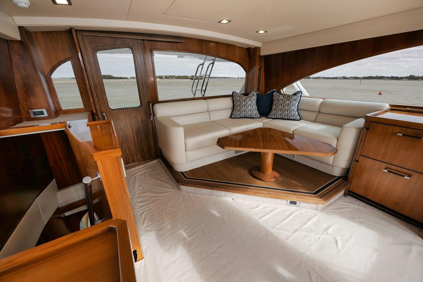 a living room with a couch and a wood table aboard COOKIE MONSTER Yacht for Sale