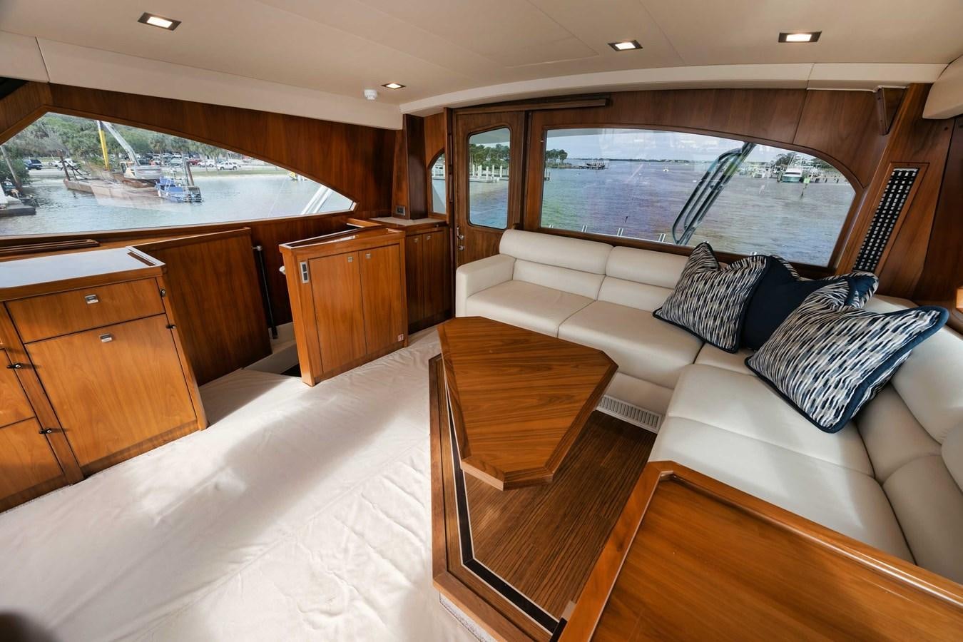 a living room with a couch and a table aboard COOKIE MONSTER Yacht for Sale