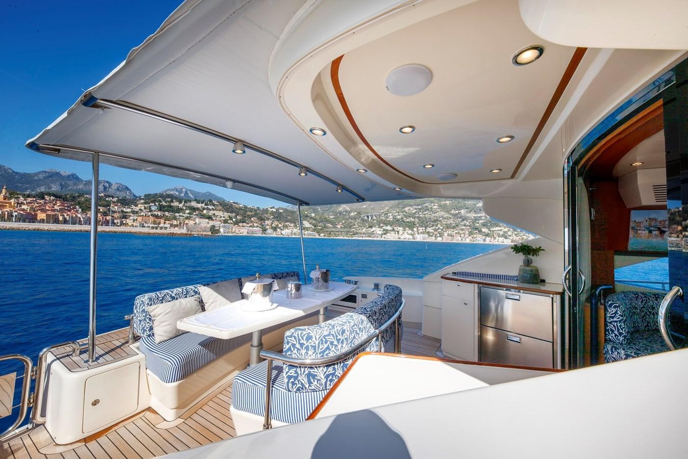 a room with a view of the ocean and a city aboard TRUE AUSTRIAN Yacht for Sale