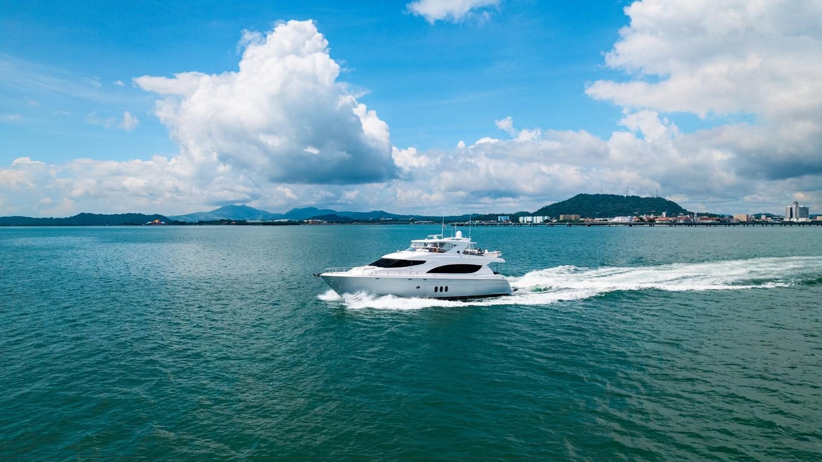 a boat on the water aboard HATTERAS 105 Yacht for Sale