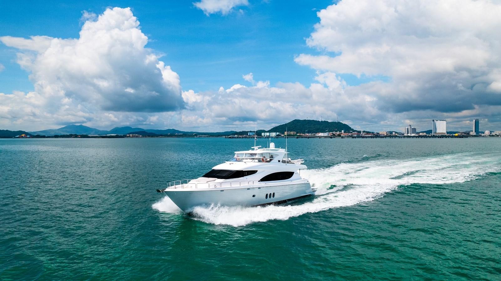 a white boat on the water aboard HATTERAS 105 Yacht for Sale