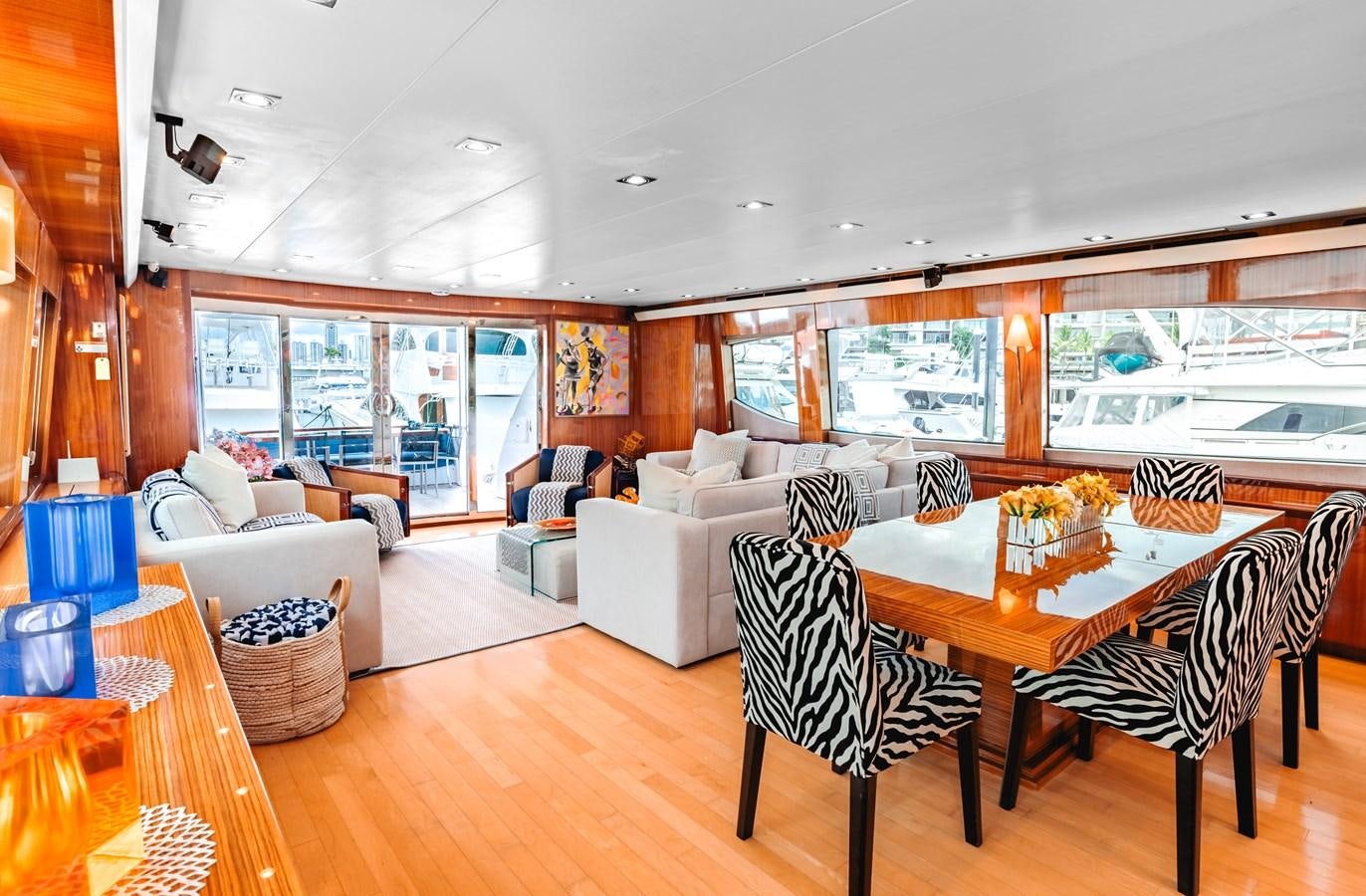 a living room with a large window aboard HATTERAS 105 Yacht for Sale