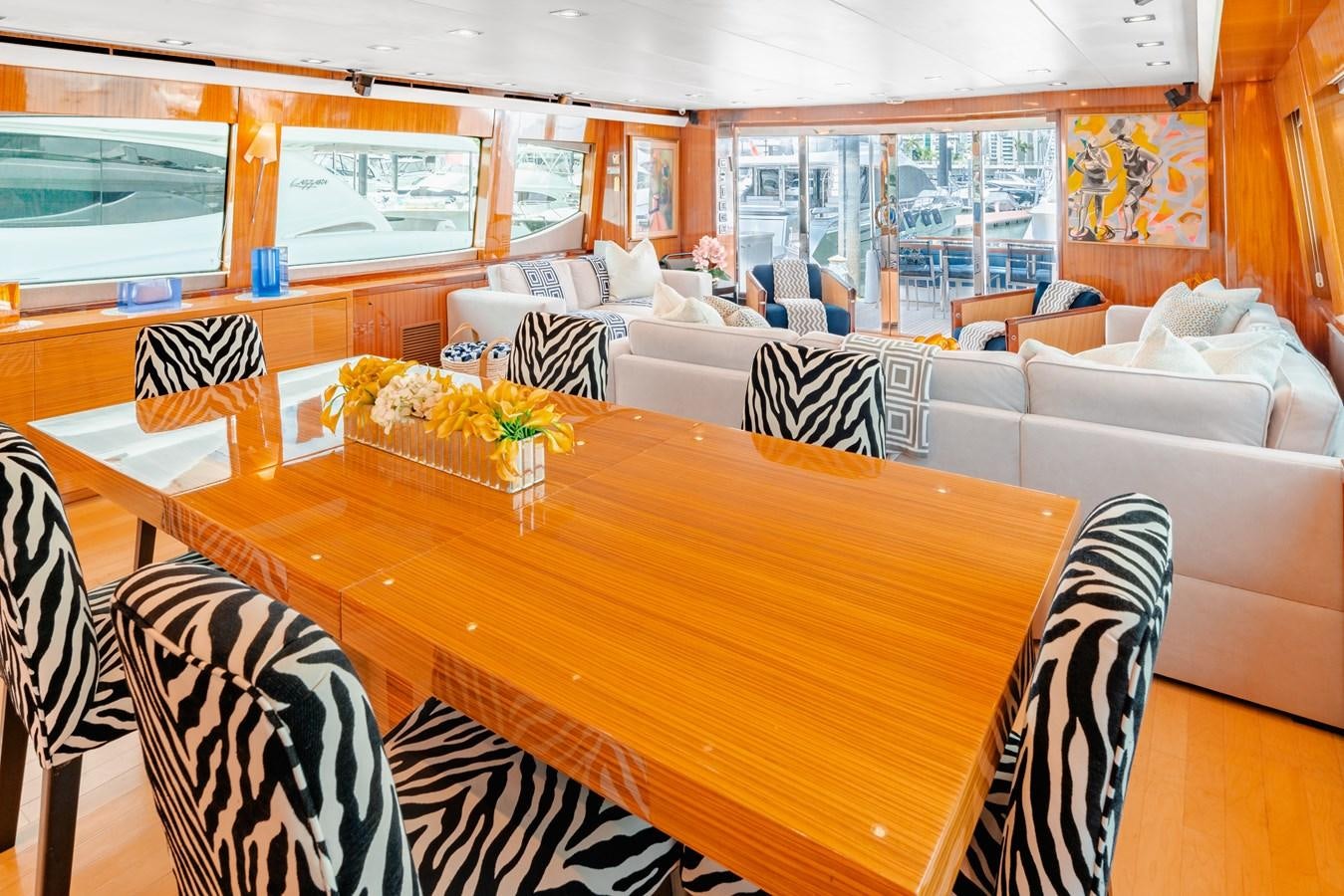 a room with a table and chairs aboard HATTERAS 105 Yacht for Sale